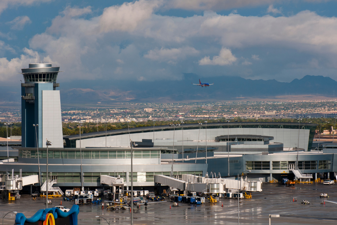 Busy Las Vegas airport with private jets lined up, showcasing the hustle and bustle of Super Bowl aviation traffic.